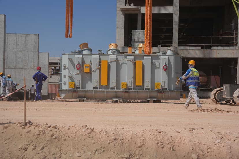 Construction workers installing a large electrical transformer at the Tosyali SULB steel complex construction site in Benghazi, Libya.