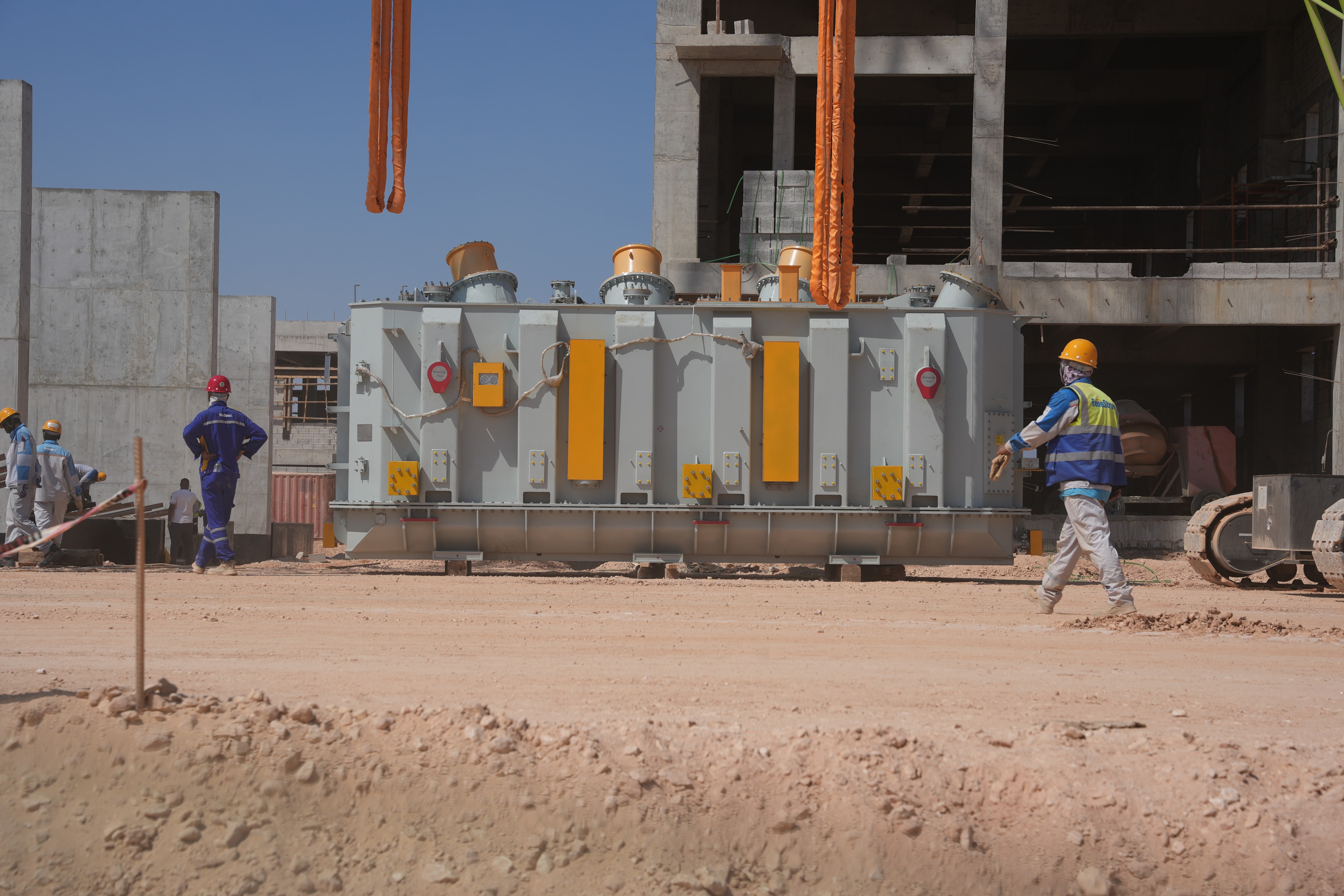 Construction workers installing a large electrical transformer at the Tosyali SULB steel complex construction site in Benghazi, Libya.